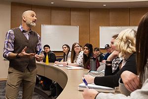 Instructor interacting with students in a classroom